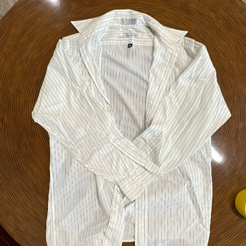 1. White Van Heusen men's dress shirt with thin vertical stripes laid out on a wooden surface.