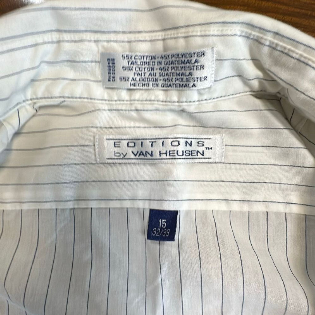 2. Close-up of the collar tags on a Van Heusen men's striped shirt, showing size and brand details.