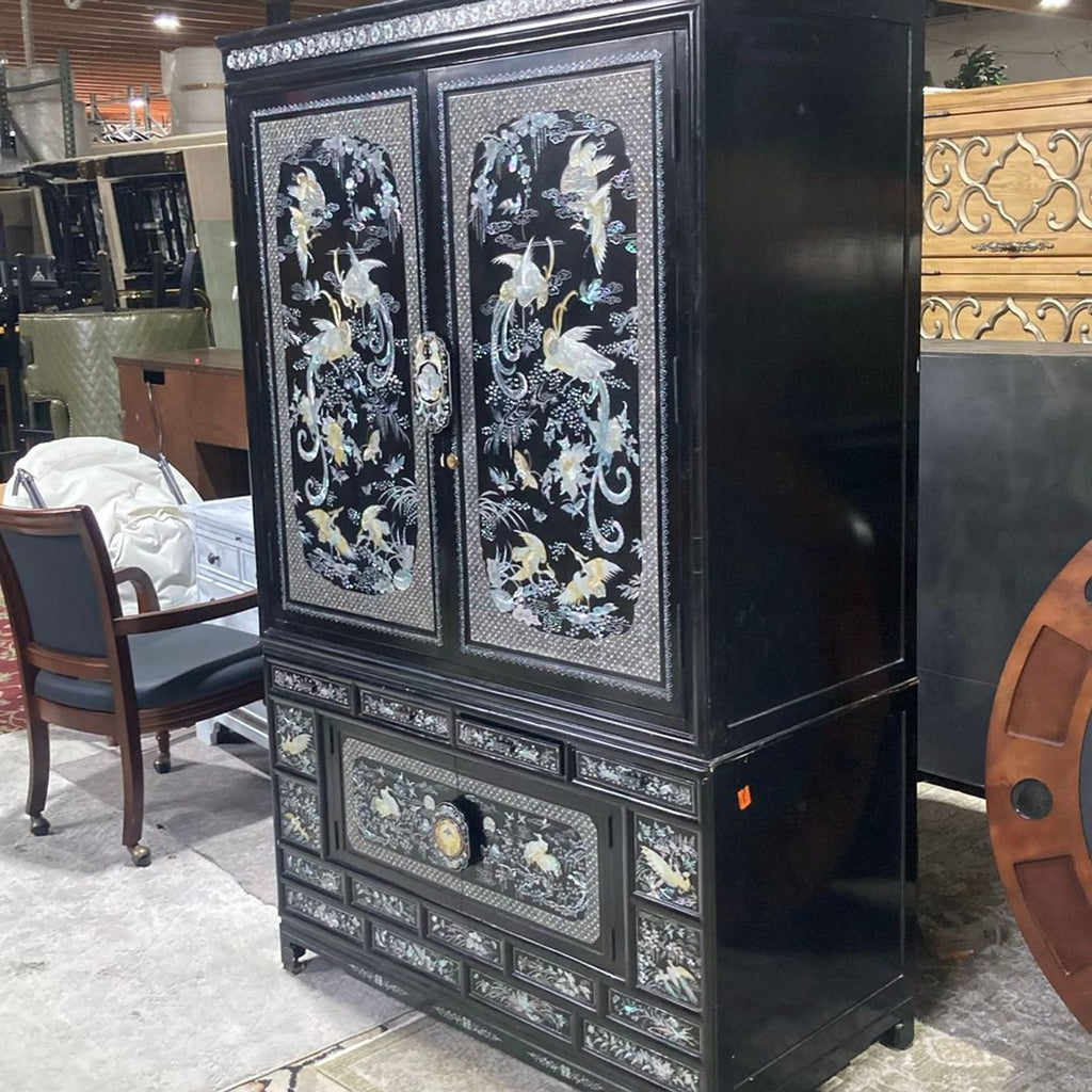 1. Black cabinet with mother of pearl inlay, featuring crane and floral designs, multiple drawers, and ornate details.