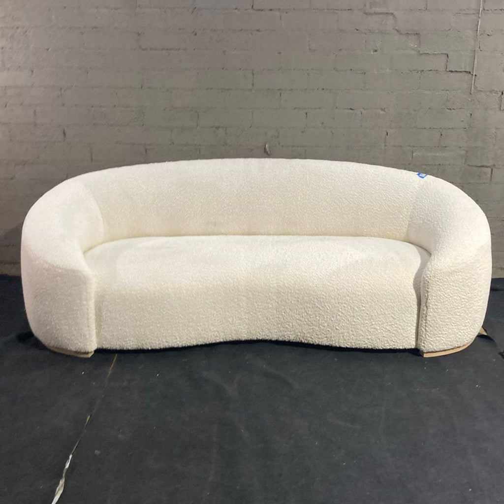 Chelsea Sofa featuring wraparound arms, tight upholstery, and an ash wood base; comfortable 3-seater design.  