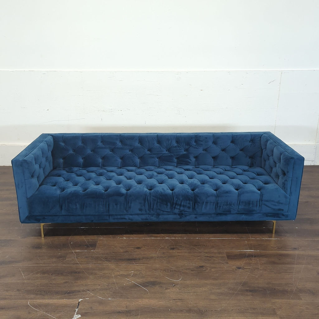 2. Stylish three-seater couch with wooden legs, designed for both comfort and elegance.