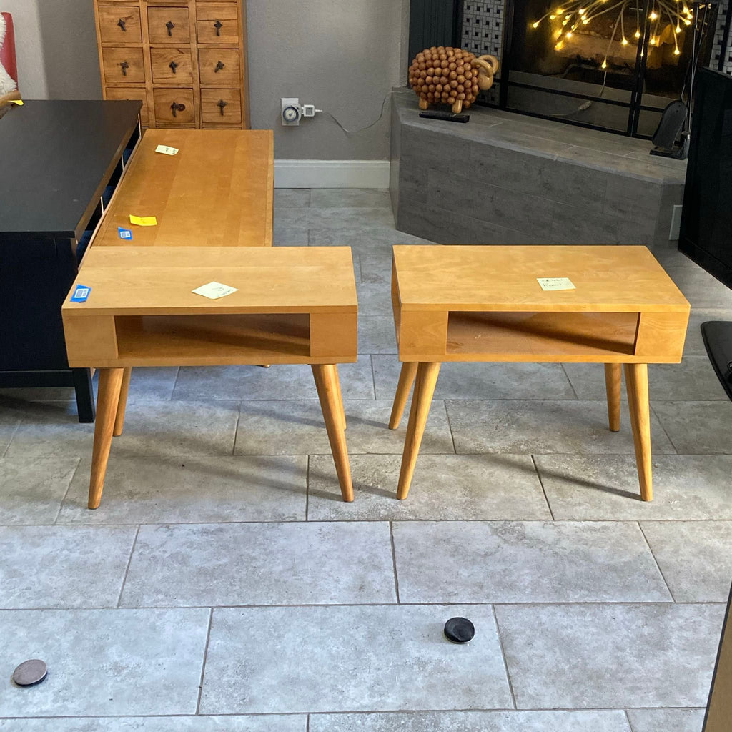 Pair of Conant Ball end tables with mid-century modern style, light wood finish, and open storage shelves.