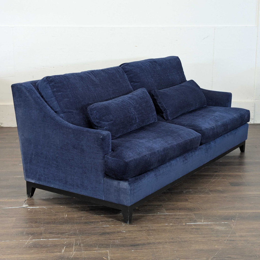 Deep blue 3-seat sofa by The Jones, featuring plush cushions and soft fabric for comfort and style.