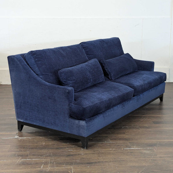 Deep blue 3-seat sofa by The Jones, featuring plush cushions and soft fabric for comfort and style.