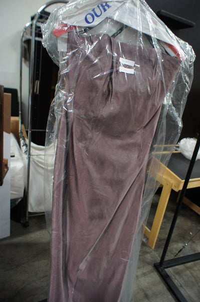1. Roberta brown women’s dress displayed on a hanger, covered in clear plastic garment bag.