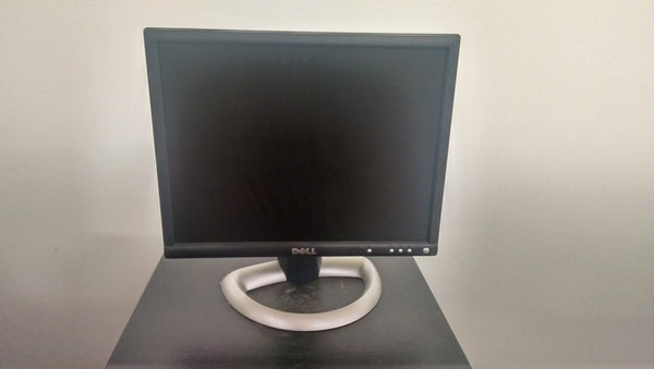 1. Dell computer monitor with a black frame and circular silver stand, displayed on a dark surface.