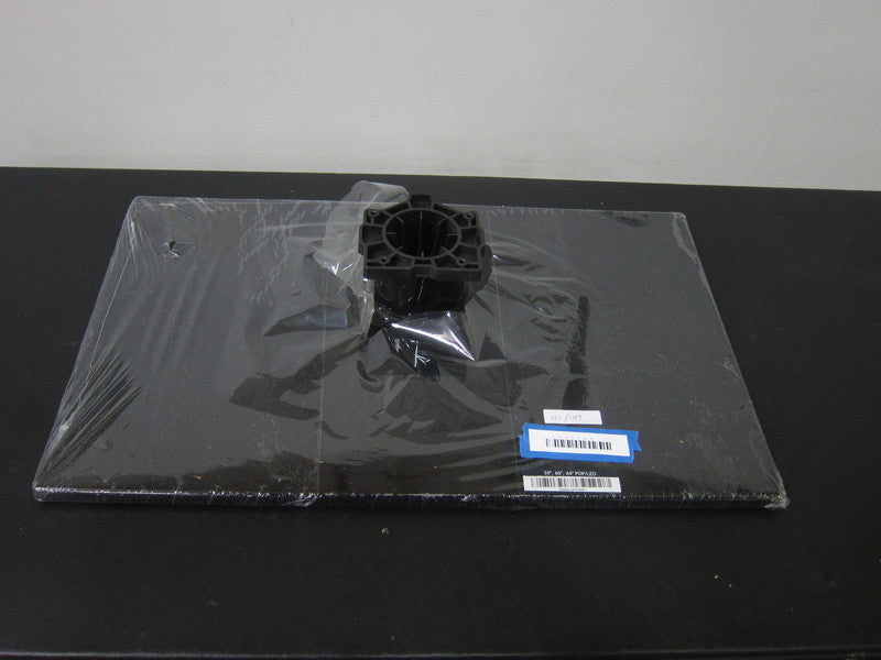 1. Reperch PDP/LED Television Stand in wrapper, black base with central mounting bracket, labeled for inventory.  