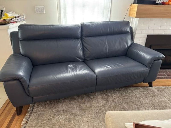 1. Dark blue Reperch 3-seat electric couch, 7ft x 3ft, with reclining seats and buttons on the sides.