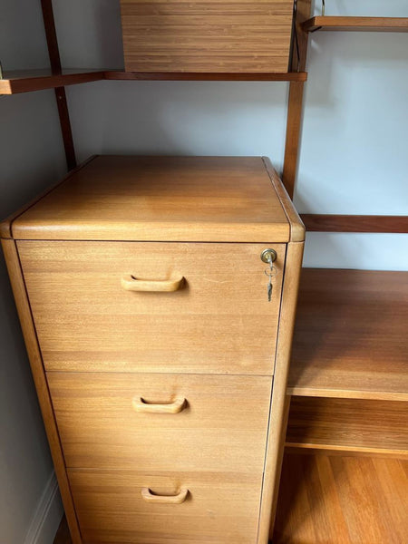 1. Reperch wooden cabinet with three drawers and a lock, shown close-up among matching shelves.