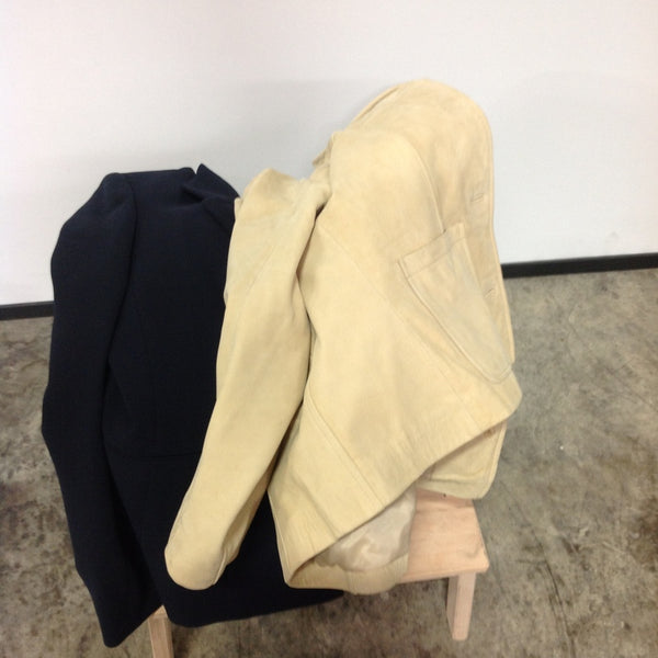 1. Beige and black women's Reperch jackets placed over a wooden bench in an indoor setting.  