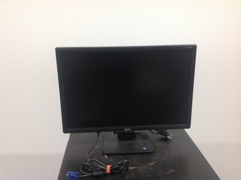 Acer computer monitor with a black frame and cables, displayed on a black surface.  