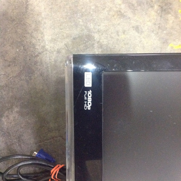 Close-up of a ViewSonic monitor corner showing "1080P Full HD" and connector cables on a concrete floor.  