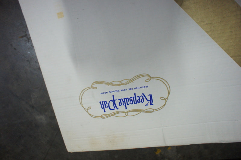 2. Partial view of Reperch Keepsake Pak box lid with decorative logo, for vintage wedding dress storage.  