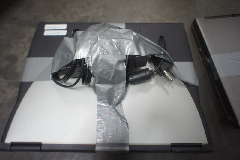 3. Reperch laptop with silver-black lid, charger cables taped on top, and inventory stickers visible.