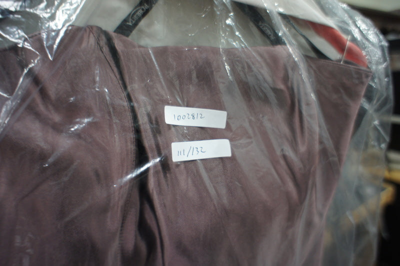 2. Close-up of the Roberta brown dress bodice, showing garment tags under plastic covering.