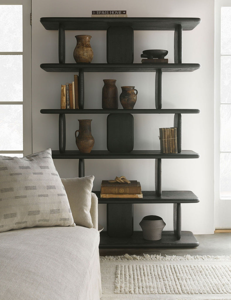 a black shelf with various vases and books.