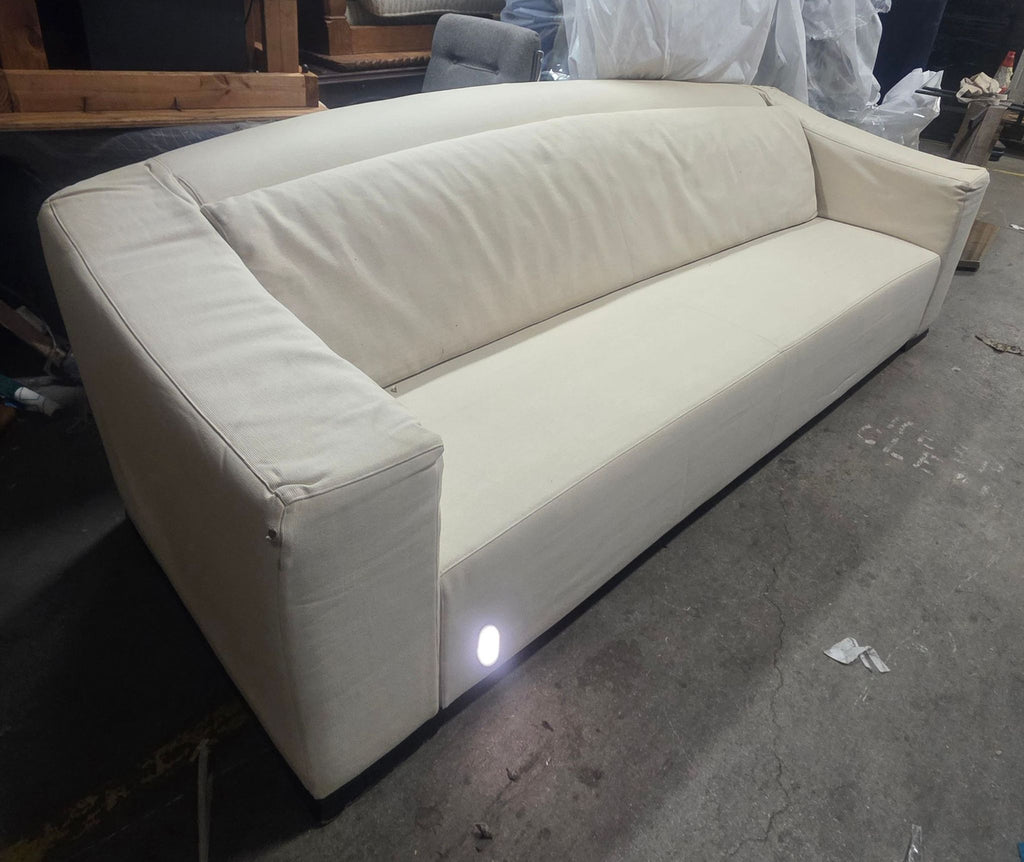 Cream-colored Armani Casa 3-seater sofa, featuring sturdy armrests, clean lines, and subtle signs of prior use.