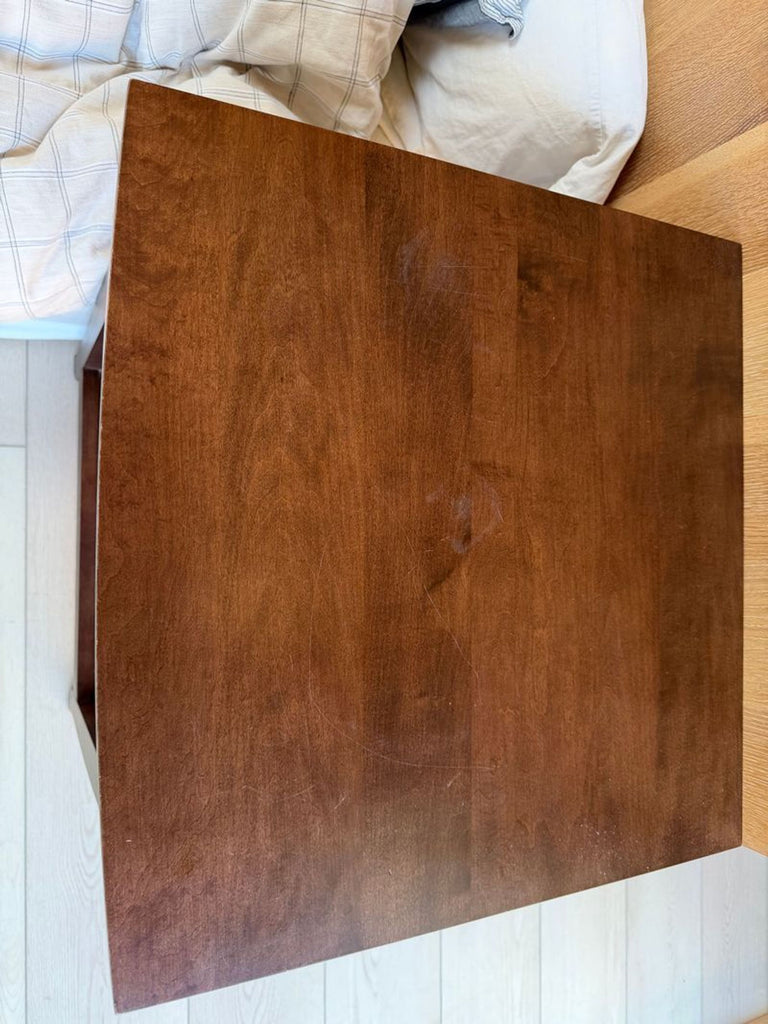 2. Top-down view of a rectangular dark wood Reperch end table showcasing its smooth, scratch-marked surface.  