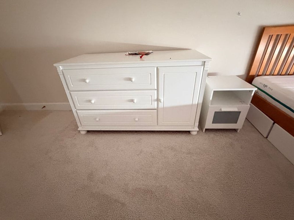 Simple wooden dresser with six drawers, suitable for bedroom or living spaces.  