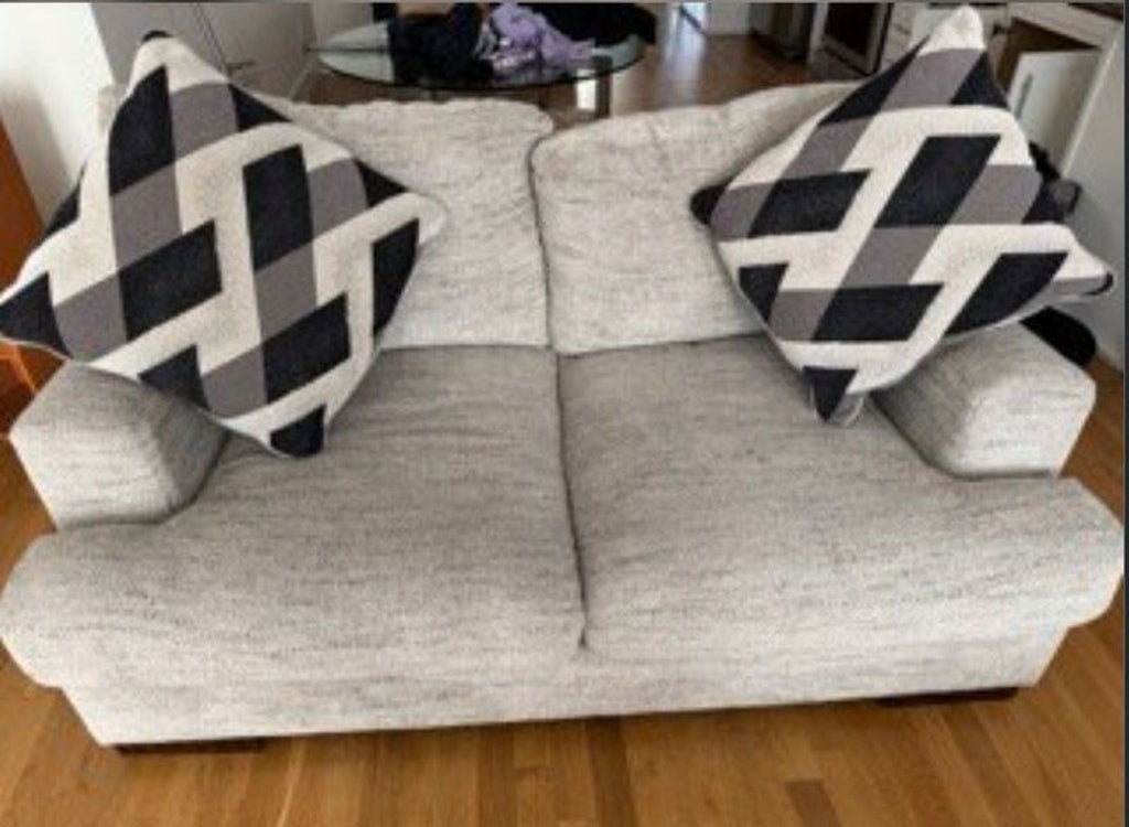 1. Reperch loveseat with light gray upholstery, two geometric-patterned pillows, shown on a wooden floor.