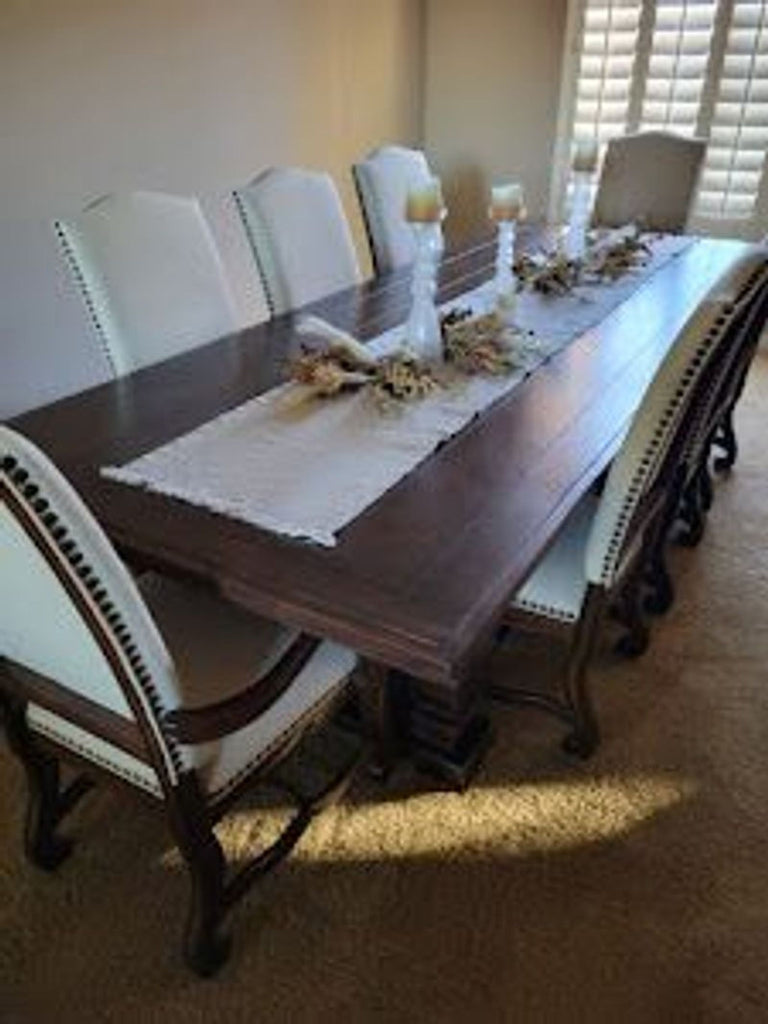 Dining set by A.R.T. Furniture, includes spacious wooden table and eight comfy, nailhead-trimmed chairs.