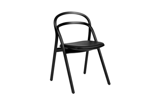 Modern dining chair with bentwood frame, upholstered leather seat, and visible wood grain by Hem.  