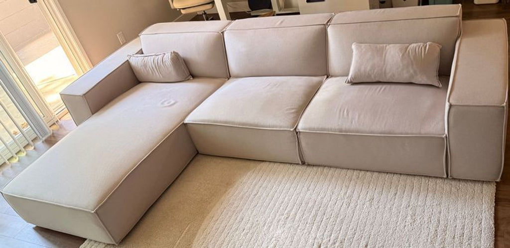 Sectional couch in neutral tone, 2022 model by Rove Concepts, featuring light pilling on upholstery.