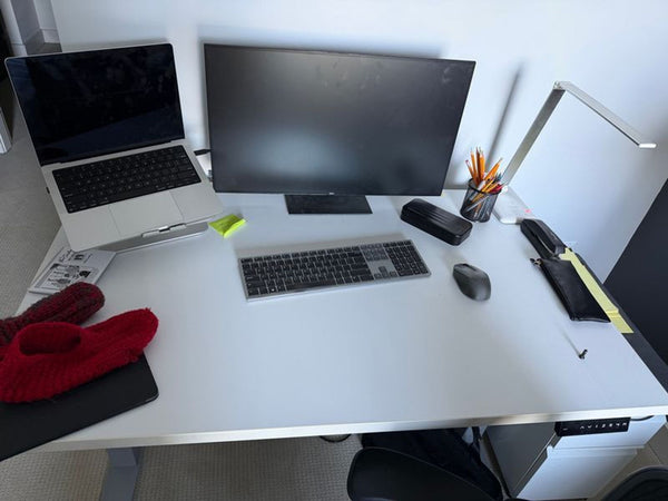1. Reperch desk with a monitor, laptop, lamp, keyboard, and office supplies organized on a white tabletop.