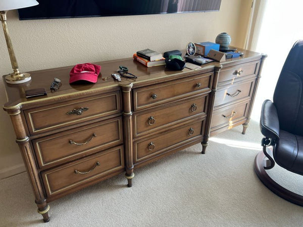 1. Dixon-Powdermaker dresser with nine drawers, adorned with personal items on top, placed in a bedroom.  