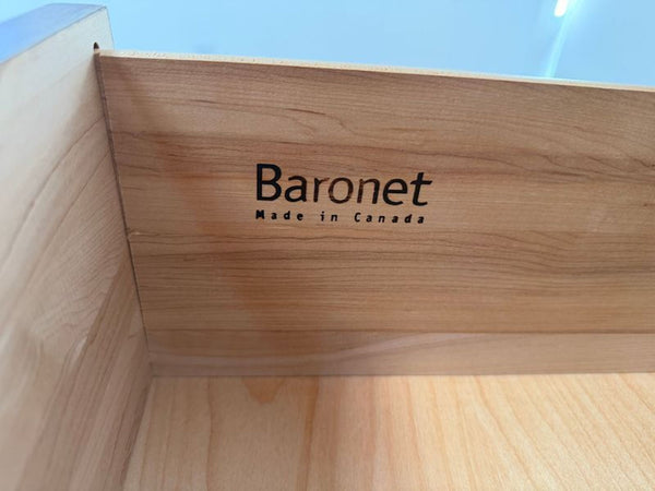 1. Close-up of a wooden dresser drawer interior showing "Baronet Made in Canada" branding.