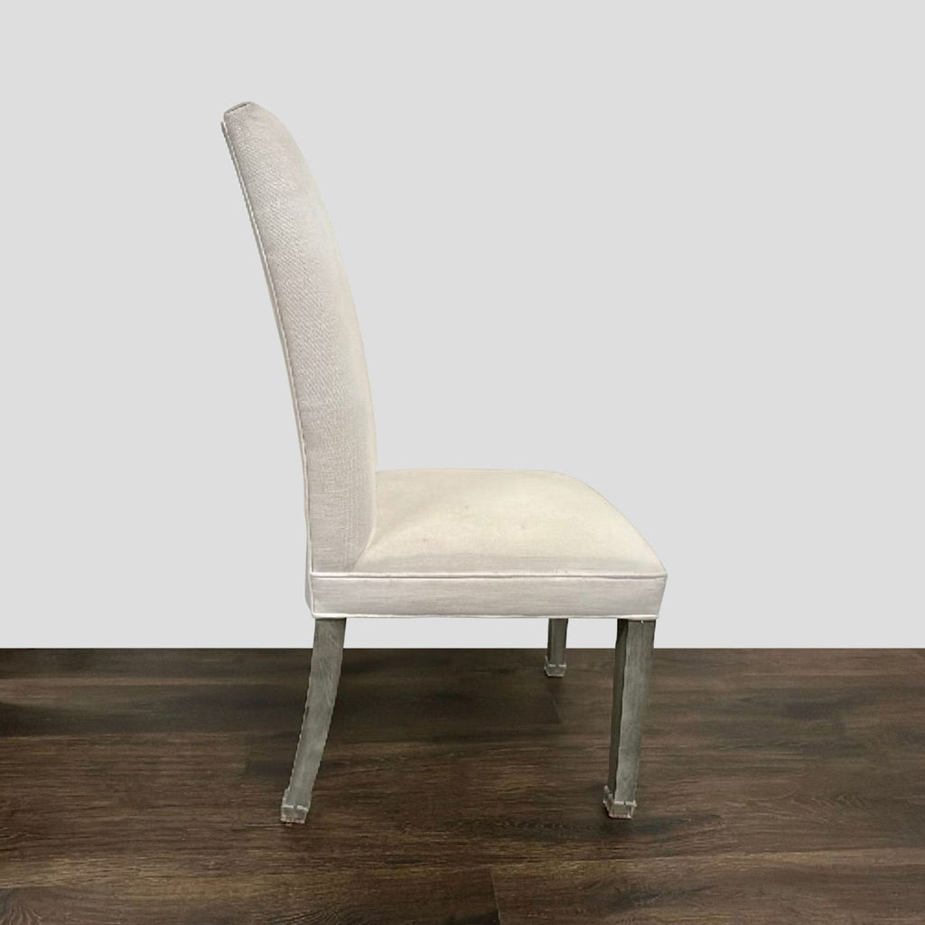 Elegant rectangular dining table with six white chairs, perfect for family meals; Restoration Hardware brand.
