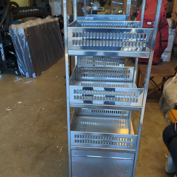 1. Metal utility cart with four perforated shelves and wheels, shown in a garage setting among other stored items.