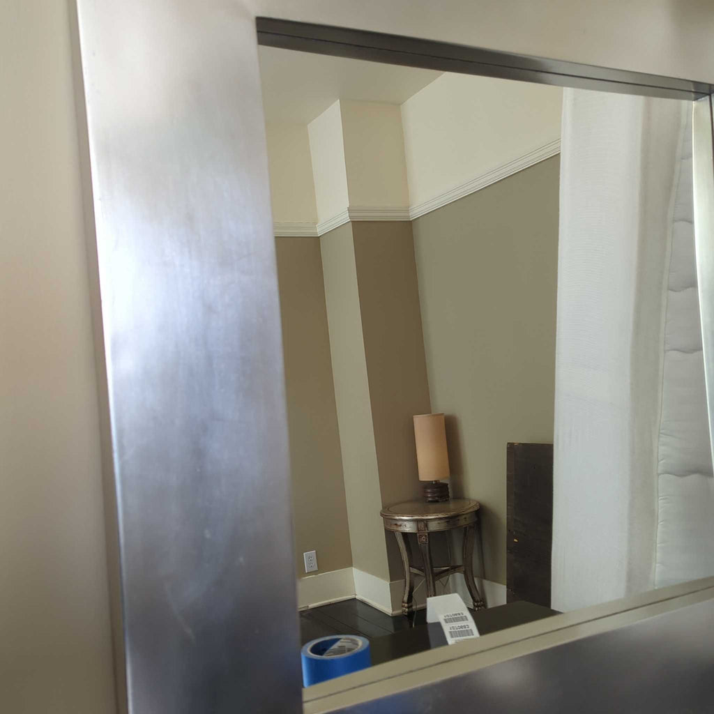 Elegant wall-mounted mirror with a simple, contemporary frame, perfect for any living space.