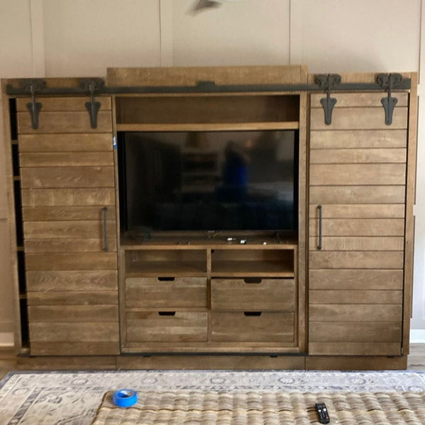 Arhaus entertainment center made of hand-planed solid American oak with antique rust patina and vintage hardware.