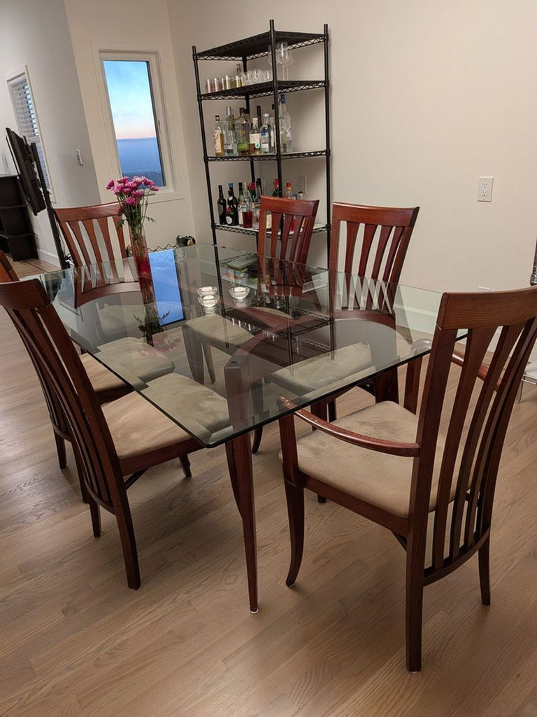 Z Gallerie glass dining table set with six matching chairs, two with arms, in a modern style.