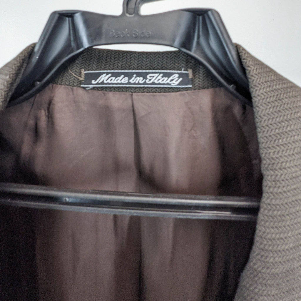 Close-up of the label reading "Made in Italy" inside the trousers.