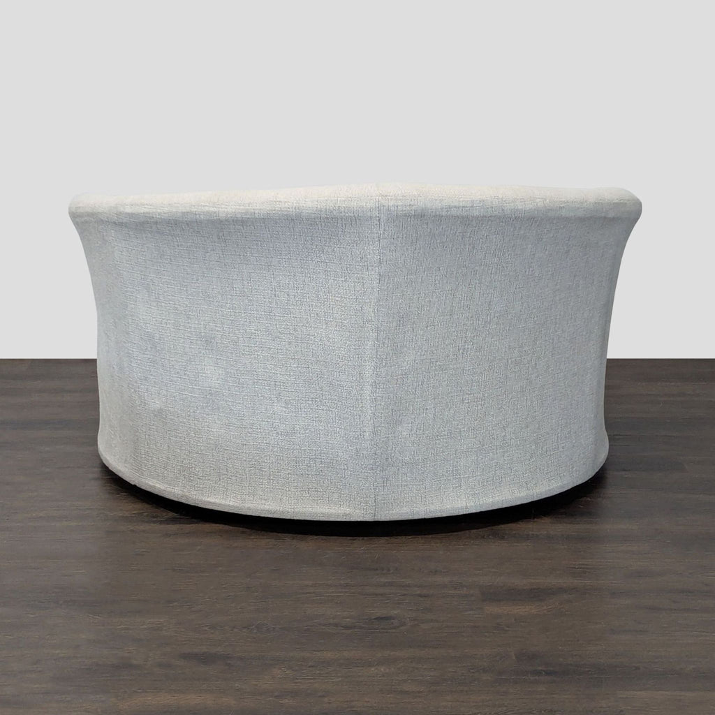Ashley Furniture lounge chair, featuring a soft beige boucle fabric and modern circular design, ideal for lounges.  