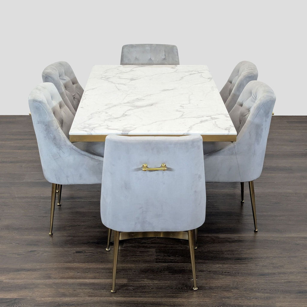 Contemporary dining set by Wayfair with a marble-top table and six gray velvet, gold-accented chairs.