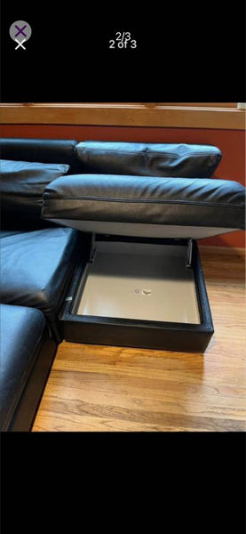 Modular black faux leather sectional sofa with sleeper and storage ottoman, shown disassembled for transport.