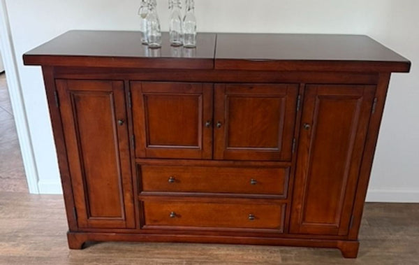1. Wooden cabinet from Furniture Pic 6, featuring two doors and modern handles, shown in a bright room setting.  