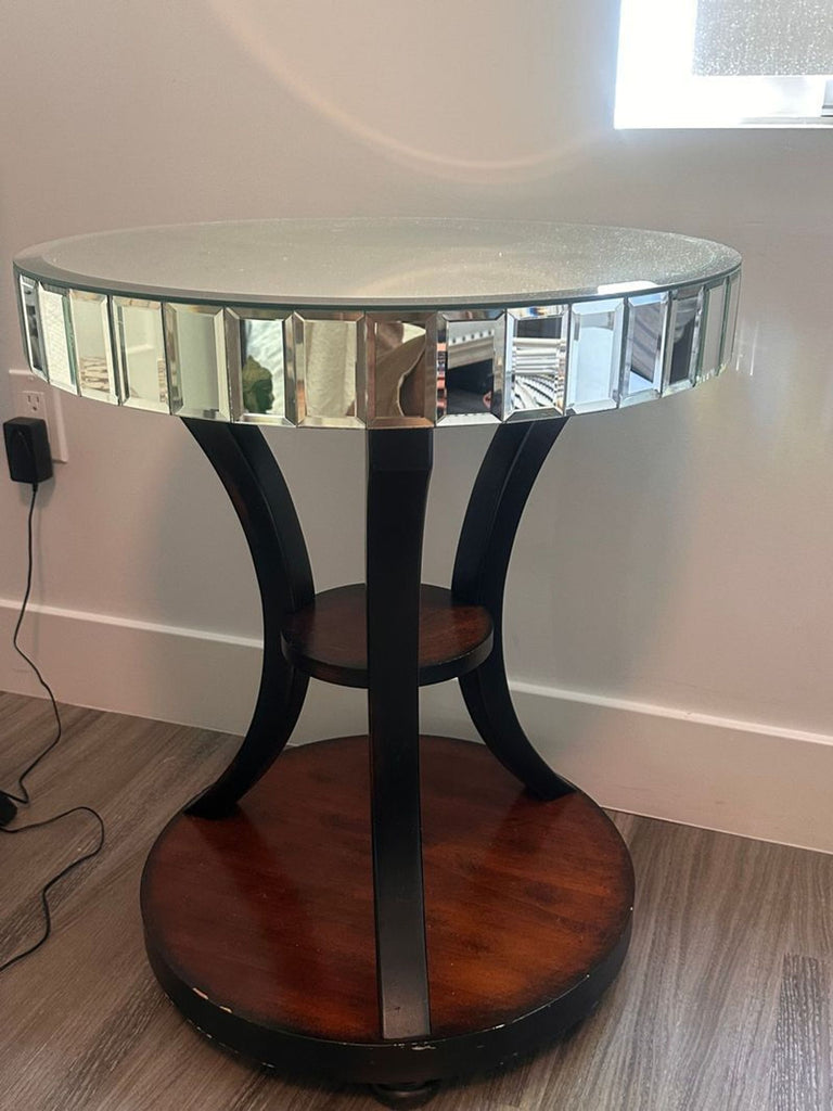 1. Z Gallerie end table with mirrored round top, curved black legs, and two wooden shelves on wood flooring.