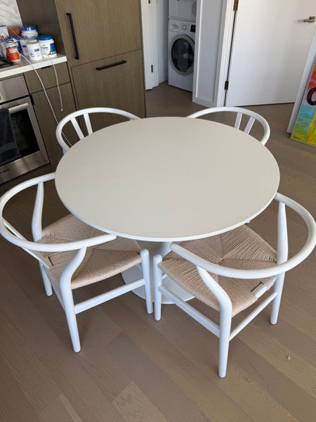 A compact dining set featuring a coffee table and two chairs with a modern design.