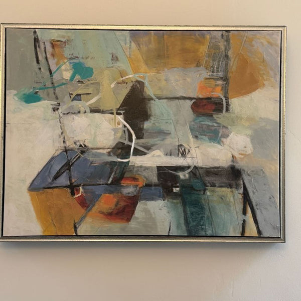 1. Abstract painting featuring bold strokes of blue, orange, black, and white, encased in a thin modern frame.