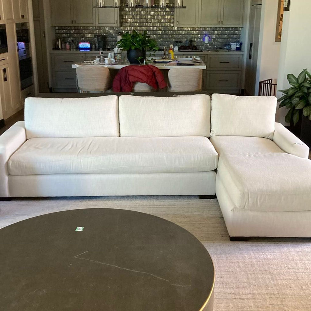 1. Restoration Hardware sectional sofa in cream fabric, L-shape with chaise lounge, placed in a modern living room.