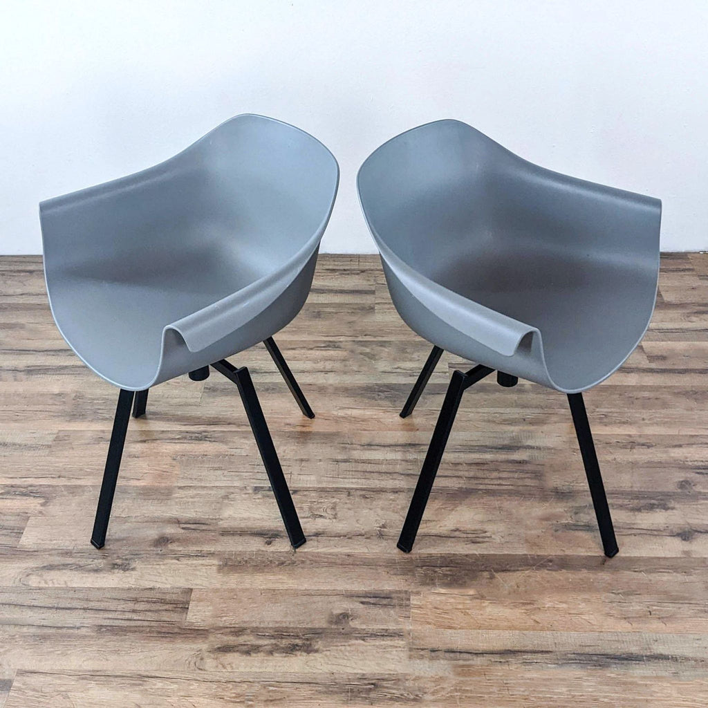 Modern dining chairs with polypropylene seats and metal swivel bases.