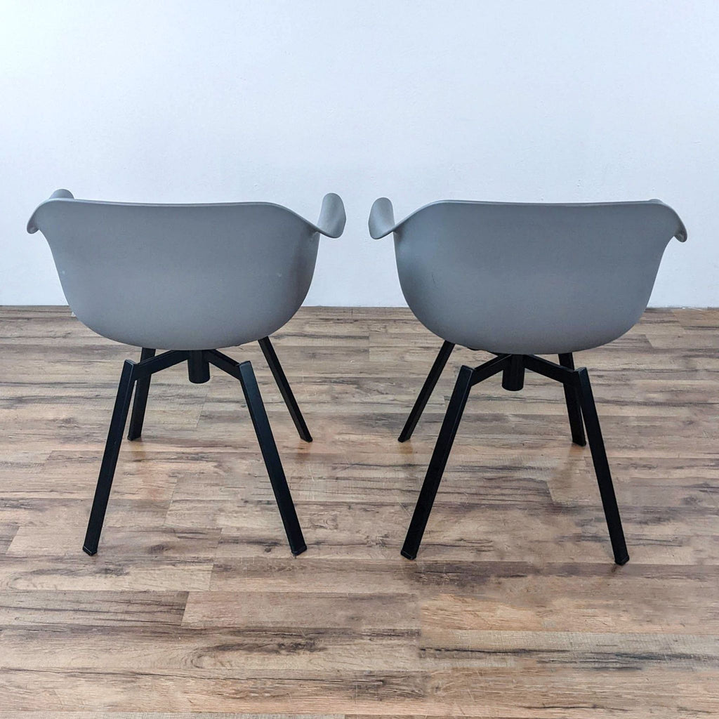 Two Reperch dining chairs featuring sleek, euro-style design.
