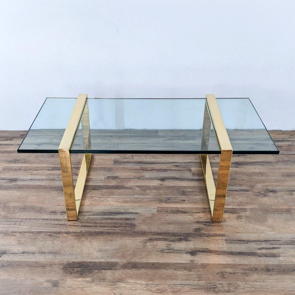 a glass and brass coffee table