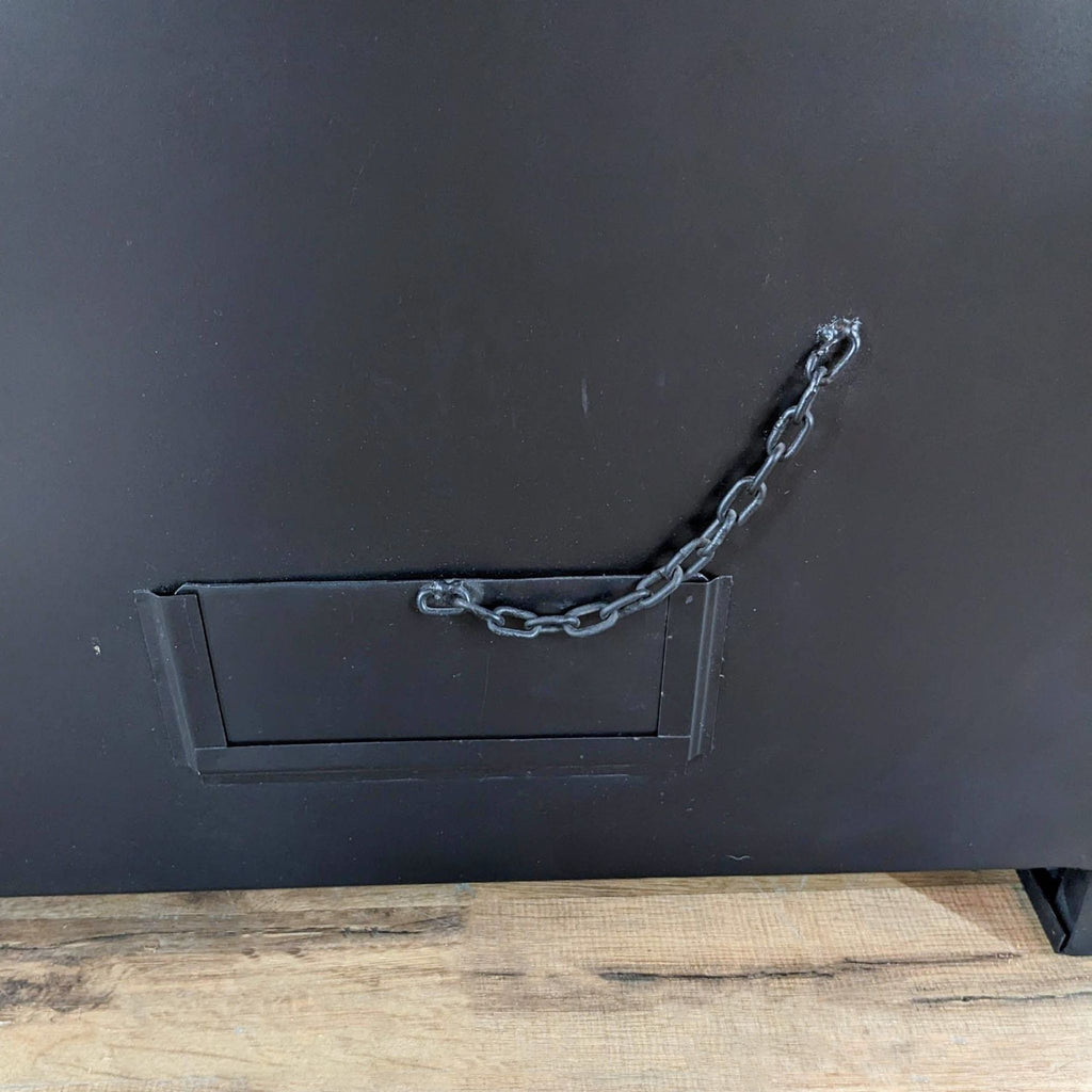 a vintage metal cabinet door with a chain.