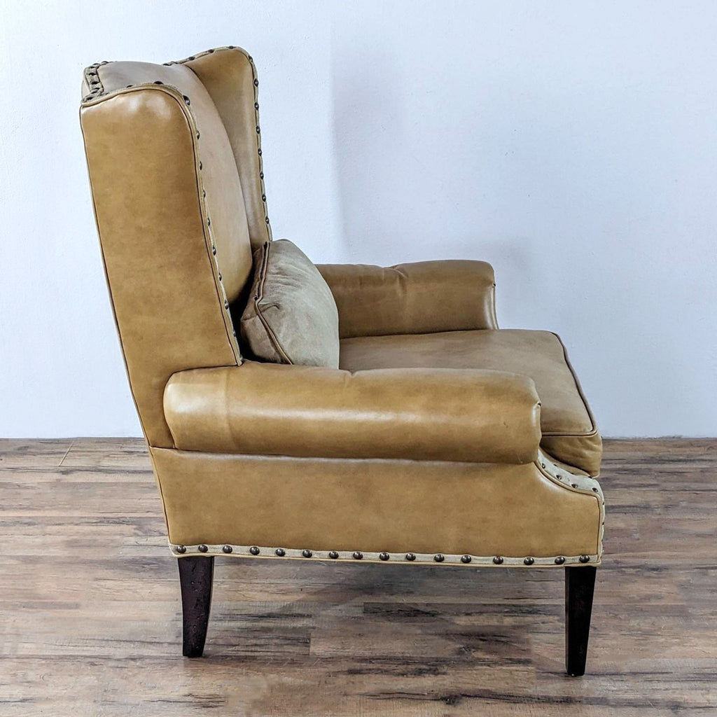 a vintage leather club chair with a leather back and a leather cushion.