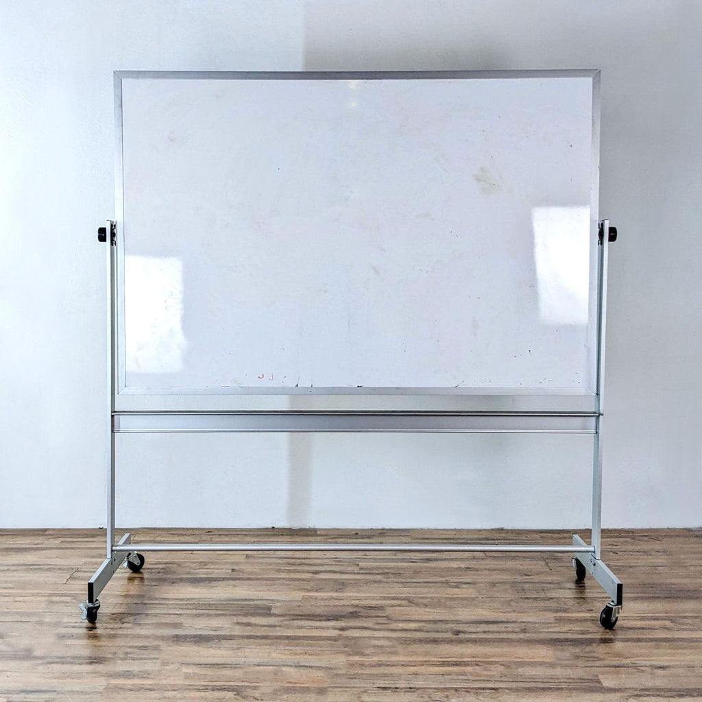 Portable dry erase board on wheels, front view, with marker tray.